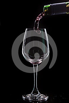 Red wine pouring into a wine glass