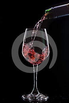 Red wine pouring into a wine glass