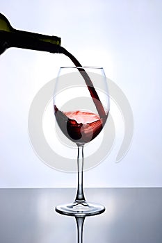 Red wine pouring into wine glass