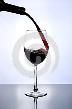 Red wine pouring into wine glass