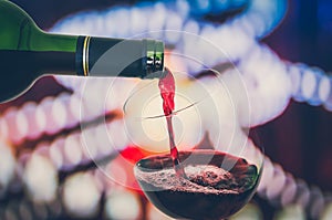 Red wine pouring into a wine glass - celebration concept