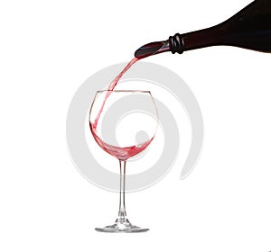 Red wine pouring into wine glass isolated