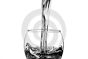 Red wine pouring into wine glass isolated on white background.