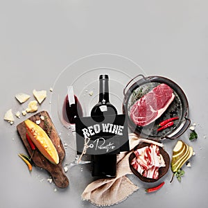 Red wine Primitivo with appetizers on gray background photo