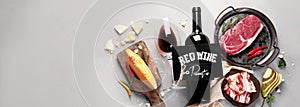 Red wine Primitivo with appetizers on gray background photo