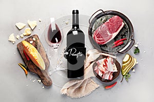 Red wine Primitivo with appetizers on gray background photo