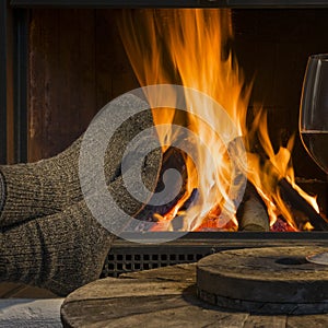 Red wine relaxing at fireplace in winter