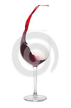Red wine splashing out of a glass, isolated on white