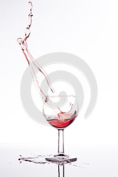 Red wine splash over white background 2