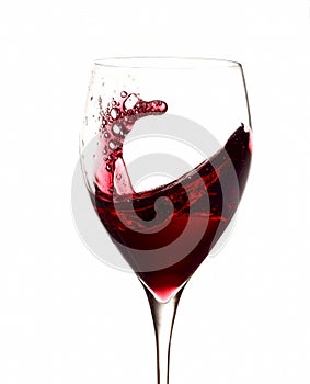 Red wine splashing in glass