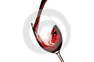 Red wine splashing in a glass, isolated on white