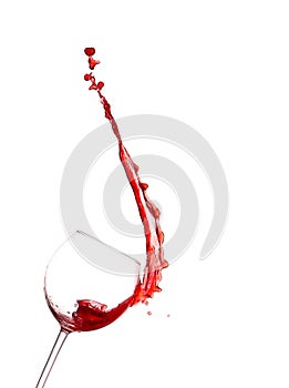 Red wine splashing from glass,