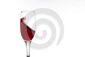 Red wine is splashing in a glass