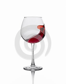 Red wine splashing out of a glass isolated on white