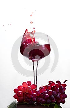 Red wine splashing in the wine glass