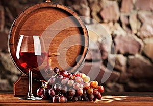 Red wine.Still life with glass of red wine, grapes and barrel.Selective focus.Copy space