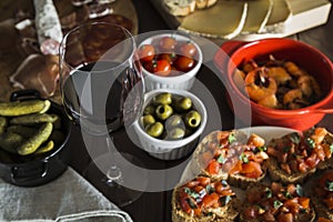 Red wine and tapas dishes on a wooden table