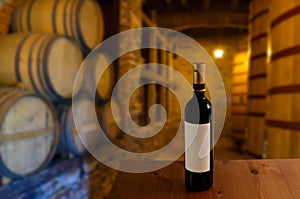 Red wine tasting in an old wine cellar with wooden wine barrels in a winery