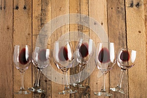 Red wine in transparent wine glasses on a wooden background. Bojole nouveau, wine bar, winery, winemaking, wine tasting concept,