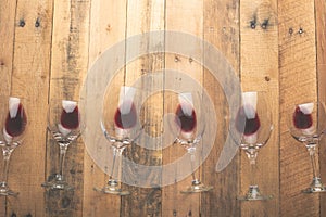 Red wine in transparent wine glasses on a wooden background. Bojole nouveau, wine bar, winery, winemaking, wine tasting concept,