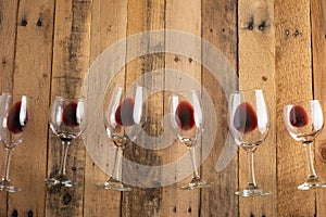 Red wine in transparent wine glasses on a wooden background. Bojole nouveau, wine bar, winery, winemaking, wine tasting concept,