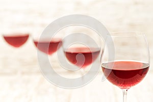 Red wine on a white wooden background, close up