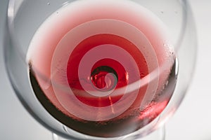 Red wine on a wineglass close up photo