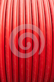 Red wire cable in reels close up on coil
