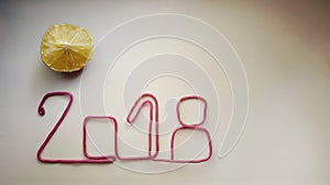 the red wire forms the number 2018 on a warm white background