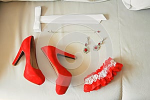 Red women`s shoes stand on the windowsill, wedding, boutonniere photo