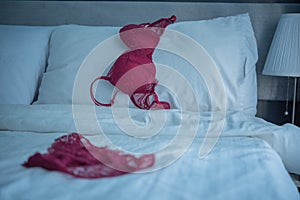 Red women underware on white bed