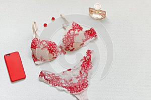 Red womens lingerie and accessories on white surface. Flat lay. Copy space.