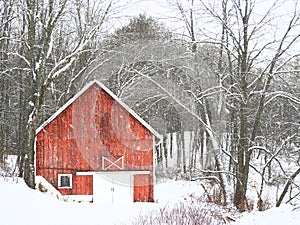 Red wood barn in winter snow landscape