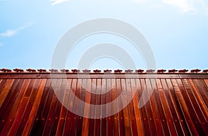 Red wood table on blue sky background