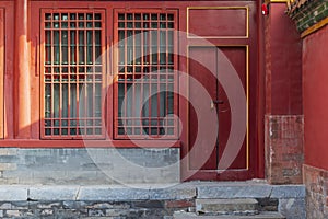 Red wood window and door, decoration colorful painting beam and wood pole from ancient china palace in forbidden City, Beijing,