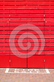 Red wooden background or texture. Fire exit sign.