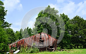 Red Wooden Barn Lies in Ruins