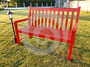 Red wooden bench in the park