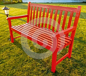 Red wooden bench in the park