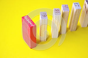 Red wooden block among the colorless on yellow background. Business planning, Risk Management, Solution, leader, strategy,