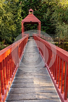 Red wooden bridge over the Arnoia river in the town of Allariz. Province of Ourense. Galicia, Spain photo