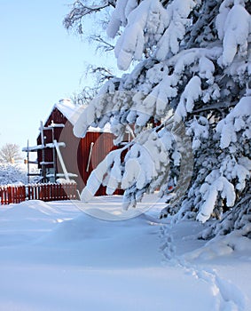 Red wooden building and lots of snow