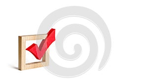 red wooden checkmark for voting on elections on a white background. Presidency or parliamentary elections, a referendum. Survey photo