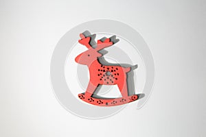 Red wooden christmas deer ornament on white