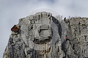 Red wooden climber house in the Lakatnik rocks and Alpine climber, Iskar river defile, Sofia province