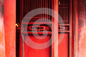 Red wooden doors in the Temple of Literature Quoc Tu Giam, Hanoi, Vietnam