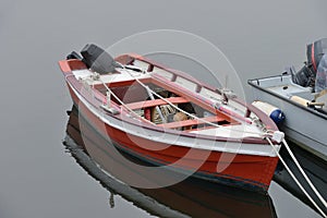 Red wooden fishing boat moored