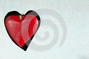 Red wooden heart on a blue board