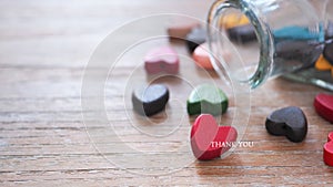 Red wooden heart and glass bottle with hearts in it, selective focus.