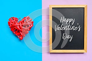 Red wooden heart handcraft and blackboard written with Happy Valentine`s Day